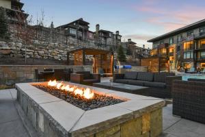 a fire pit in the middle of a patio at Modern 1BR Residence in Canyons VillageSki In Out in Park City