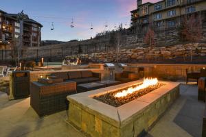 a patio with a fire pit with fires in it at New & Luxury 2 BR in Canyons Village - Ski in & out! condo in Park City