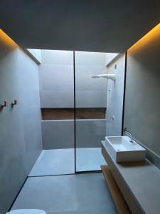 a bathroom with a sink and a shower at Casa Encanto dos Milagres in São Miguel dos Milagres