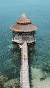 a person standing on a dock in the water at El Embrujo Tintipan in Tintipan Island