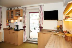 a kitchen with a large sliding glass door to a patio at Pension Pitze in Sölden