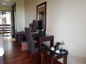 a desk with a computer and a chair in a room at Jiwa Jawa Resort Bromo in Bromo