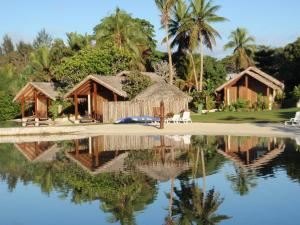 a resort with a reflection in a body of water at MG Cocomo Resort Vanuatu in Port Vila