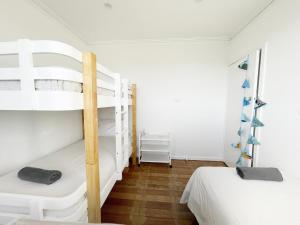 a bedroom with two bunk beds and a wooden floor at Rye Pier Apartment in Rye