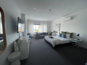 a bedroom with a bed and a living room at Rye Pier Apartment in Rye