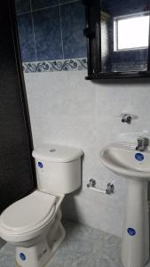 a bathroom with a toilet and a sink at Finca Hotel - Piscina La Johanna in La Mesa