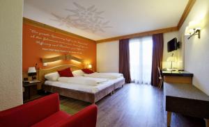 Rúm í herbergi á Hotel Kirchbühl Superior