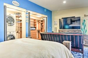 a bedroom with a bed and a flat screen tv at Albuquerque Studio with Shared Pool and Fire Pit! in Albuquerque