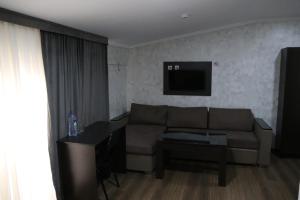 a living room with a couch and a table at Orion Hotel Tashkent in Tashkent
