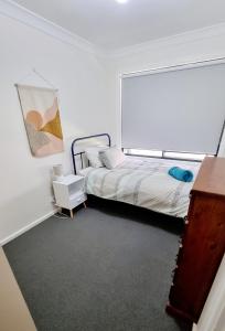 
a bedroom with a bed and a mirror at The Convent Boutique Accommodation & Cafe in Hay
