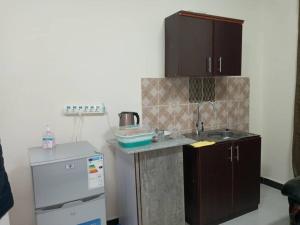 a small kitchen with a sink and a refrigerator at Betsi Bed & Breakfast (BBB) in Addis Ababa