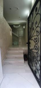 a door with a iron gate in a hallway with stairs at Fashion Villa in Bad Nauheim