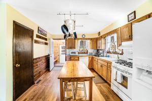 a kitchen with wooden cabinets and a wooden table at Antler Lake House in North Creek