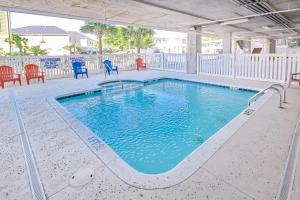 a swimming pool with a slide in the middle at Coconut Grove 203 in Myrtle Beach