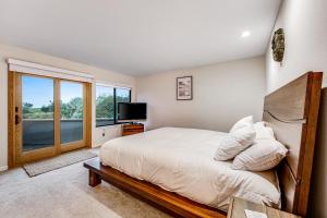 a bedroom with a large bed and a window at Latitude 38 in Bodega Bay