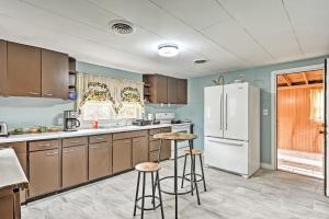 a kitchen with brown cabinets and a white refrigerator at Remodeled Abingdon House with Spacious Yard! in Abingdon