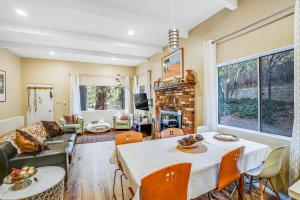 a living room with a table and chairs and a couch at Meadow Creek House in Idyllwild