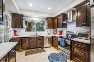 a kitchen with wooden cabinets and a sink at Meadow Creek House in Idyllwild