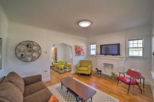 a living room with a couch and a fireplace at Colorful Tulsa Duplex with Porch Dogs Welcome! in Tulsa