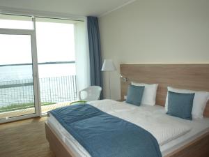 Postel nebo postele na pokoji v ubytování Strandhotel Senftenberger See