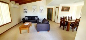 a living room with a couch and a table at The Convent Boutique Accommodation plus Short Stay Holiday Homes in Hay