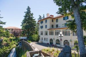 a large white building with a waterfall in front of it at Columbia Gorge Hotel & Spa in Hood River