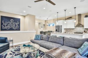 a living room with a couch and a table at Beachfront Getaway in Jacksonville Beach