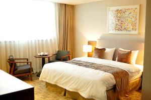 מיטה או מיטות בחדר ב-Hyunjin Tourist Hotel