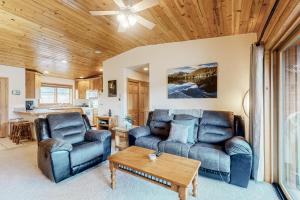 a living room with two couches and a table at Bald Mountain Views in Grand Lake
