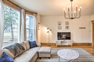 a living room with a couch and a tv at Cozy Eclectic Home about 1 Mi to Downtown Spokane in Spokane