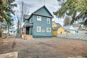 a blue house with a fence in front of it at Cozy Eclectic Home about 1 Mi to Downtown Spokane in Spokane
