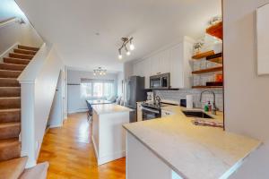 a kitchen with white cabinets and a counter top at At the Crossroads in Frisco +7 photos