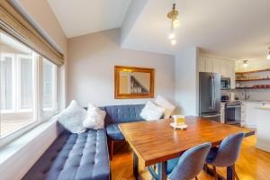 a living room with a blue couch and a wooden table at At the Crossroads in Frisco