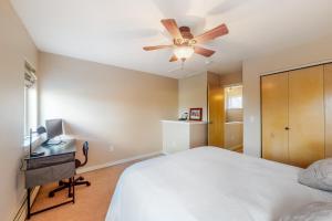 a bedroom with a bed and a ceiling fan at At the Crossroads in Frisco