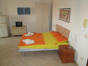 1 dormitorio con 1 cama con toallas en Residence la Piazza, en Santa Maria