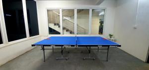 a blue ping pong table in an empty room at BluO 1BR Hitech City - Balcony, Gym, Terrace Garden in Hyderabad