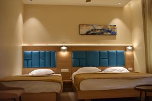 Postel nebo postele na pokoji v ubytování Hotel VPS Grand