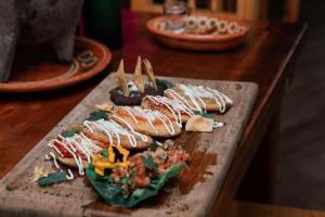 a bunch of food on a cutting board on a table at Hotel & Suites Cerro Roj0 in Tlatlauquitepec