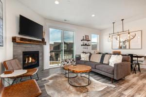 a living room with a couch and a fireplace at Quarry Springs Retreat in Park City
