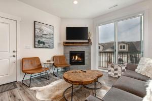 a living room with a couch and a fireplace at Quarry Springs Retreat in Park City