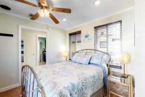 a bedroom with a bed and a ceiling fan at Pelican House in Saint Joe Beach