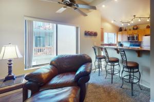 a living room with a leather couch and a bar at Settlers Run Escape in Flagstaff