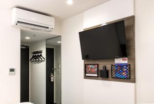 a television mounted on a wall in a room at Red Planet Tokyo Asakusa in Tokyo