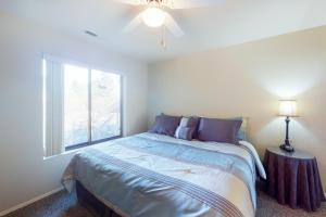 a bedroom with a bed and a window at Settlers Run Escape in Flagstaff