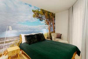 a bedroom with a bed with a view of the ocean at CHILLIapartamenty - Nadmorskie Tarasy - MORSKI z dostępem do basenu in Kołobrzeg +23 photos