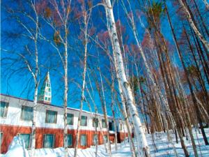 a painting of a building in the snow with trees at Arcadia in Nagano