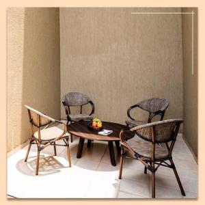 a table with three chairs and a table with a bowl of fruit at Hotel Reemz Beach Heaven , Anjuna in Anjuna