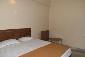 Postel nebo postele na pokoji v ubytování Hotel VPS Grand