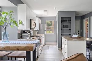 a kitchen with white cabinets and a table with chairs at Lake Escape - Table Rock Lake in Branson