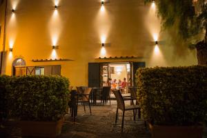 a restaurant with tables and chairs and lights on a building at Rianna Rooms & Breakfast in Scala
